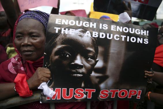 A woman holds a sign during a protest demanding the release of abducted secondary school girls from the remote village of Chibok, in Lagos May 5, 2014. The Islamist militant group Boko Haram claimed responsibility on Monday for the abduction of more than 200 schoolgirls during a raid in the village of Chibok in northeast Nigeria last month, the French news agency AFP reported, citing a video it had obtained. Boko Haram on April 14 stormed an all-girl secondary school in Chibok, in Borno state, then packed the teenagers, who had been taking exams, onto trucks and disappeared into a remote area along the border with Cameroon.  REUTERS/Akintunde Akinleye (NIGERIA - Tags: CRIME LAW CIVIL UNREST)