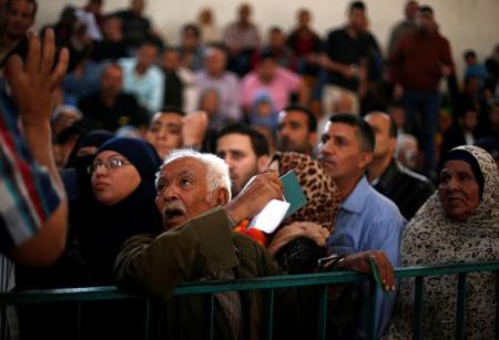 A man asks for a travel permit to cross into Egypt through the Rafah border crossing after it was opened for two days by Egyptian authorities, in the southern Gaza Strip May 11, 2016. REUTERS/Suhaib Salem